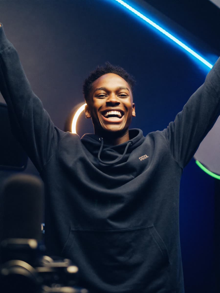 Creator celebrating in his studio as his upload takes off